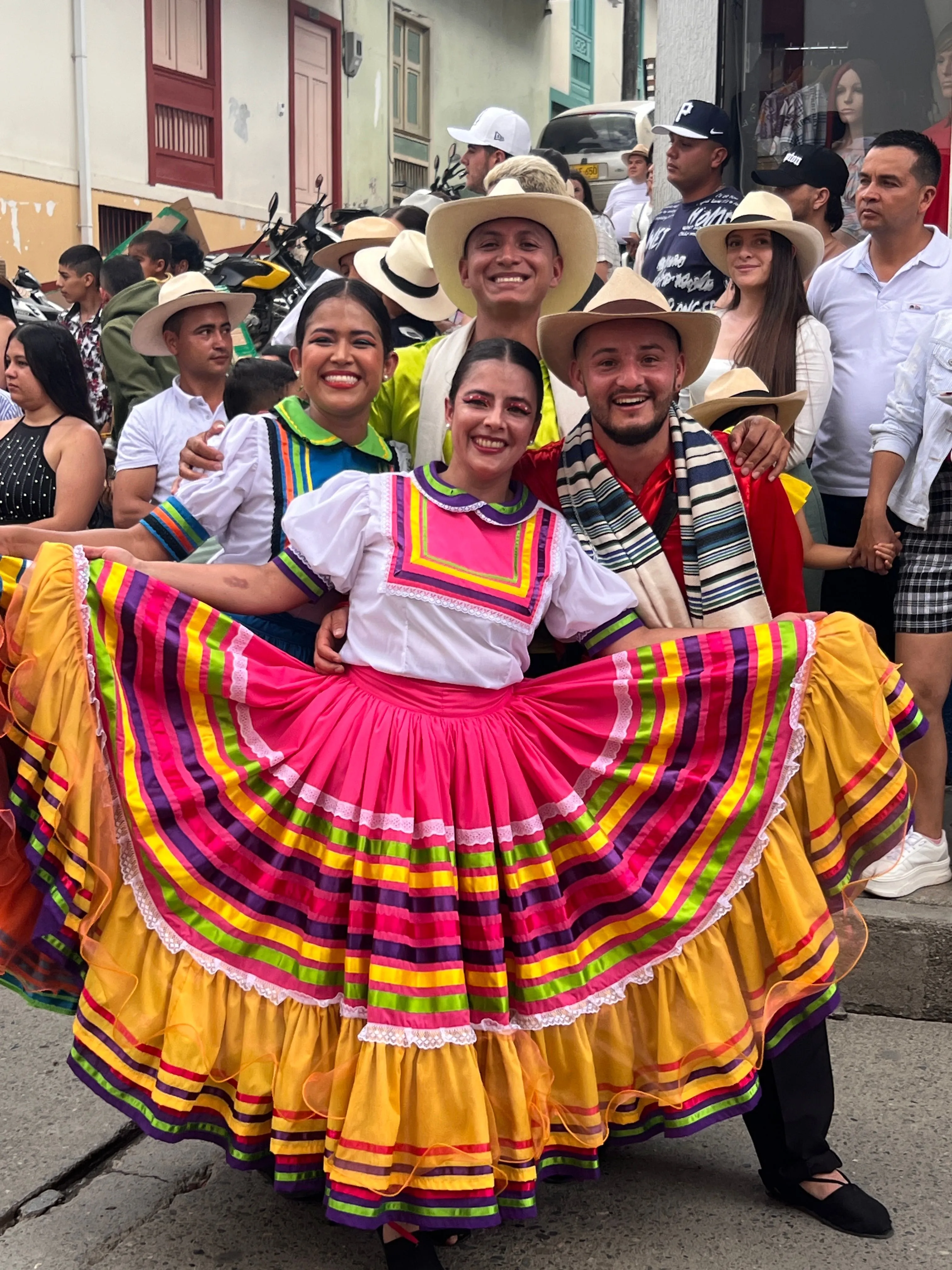 Folk dancers in traditional dress at a town festival in the Colombian Andes