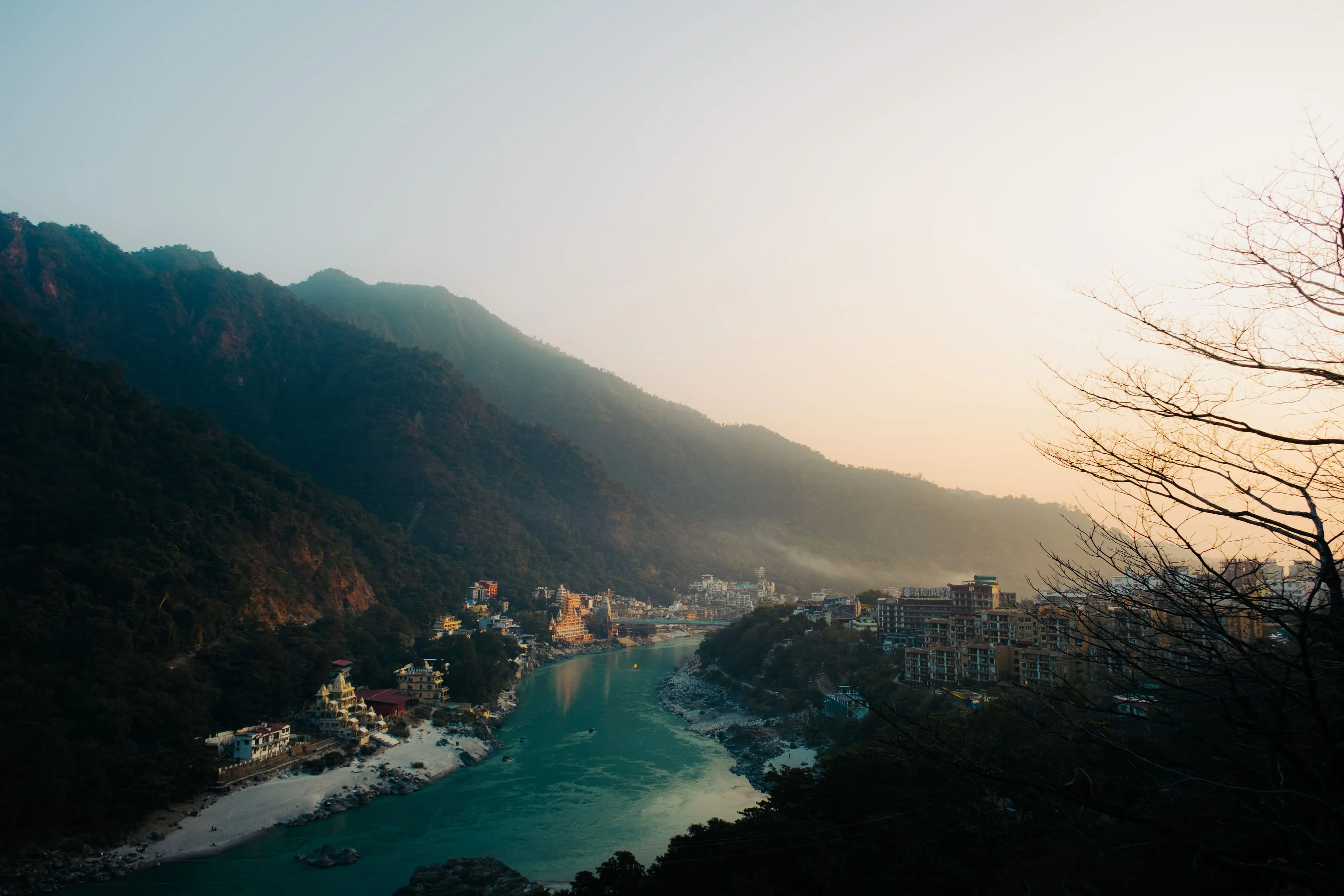 The Ganges winding between forested Himalayan foothills at dusk, Rishikesh, India