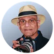Mano Chandra Dhas, founder of Coromandel Tours, holding his camera