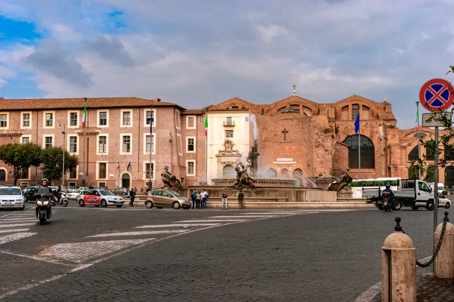 Piazza della Repubblica in Rome, with the Fountain of the Naiads in front of the brick facade of Santa Maria degli Angeli