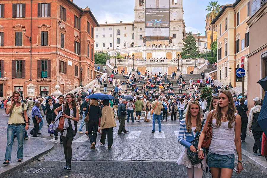 Crowds on Piazza di Spagna in Rome with the Spanish Steps rising behind them