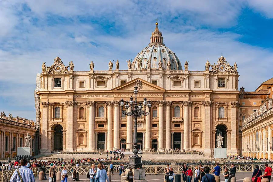 The facade and dome of St Peter's Basilica seen across St Peter's Square in Vatican City
