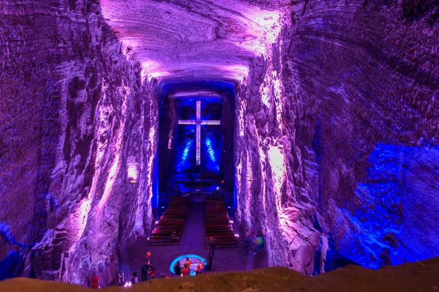 The interior of the Salt Cathedral of Zipaquirá, lit in blue with a monumental cross